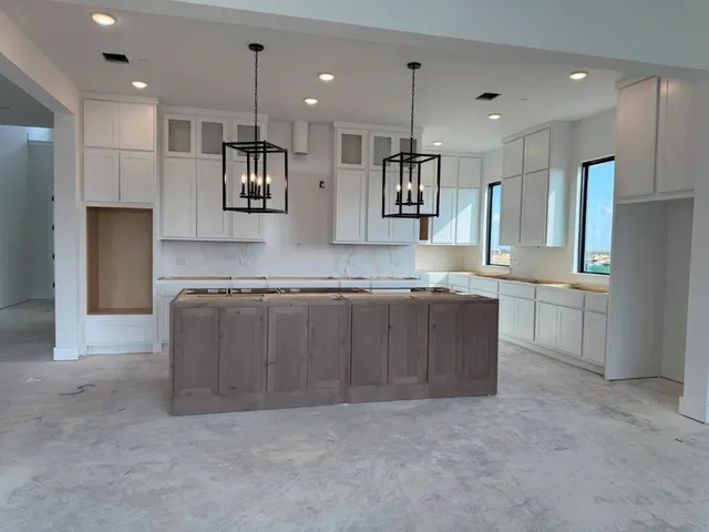 a view of a hallway with wooden floor and entryway