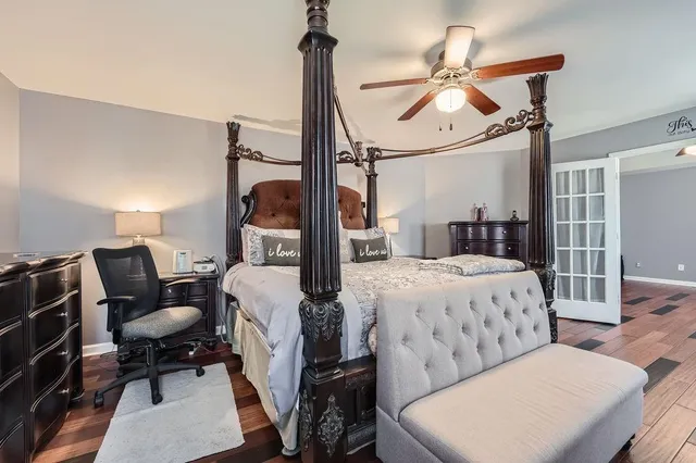 a bedroom with a bed and wooden floor