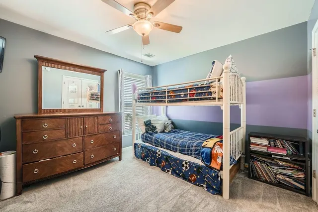 a bedroom with a bed and a baby crib