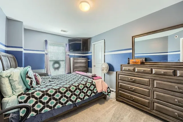 a bedroom with a bed and dresser