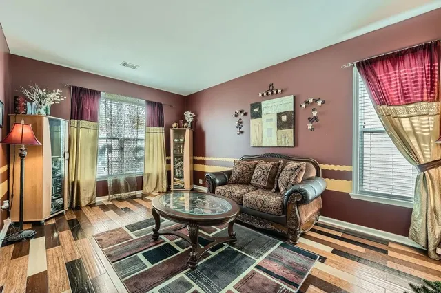a living room with furniture and a floor to ceiling window