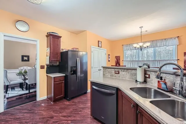 a kitchen with refrigerator and cabinets