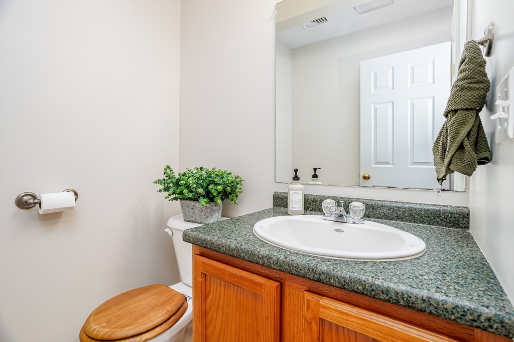 104 Lake Street, Unit 104 Gardner, MA 01440 - Photo 11 of 30 a bathroom with a granite countertop sink and a mirror