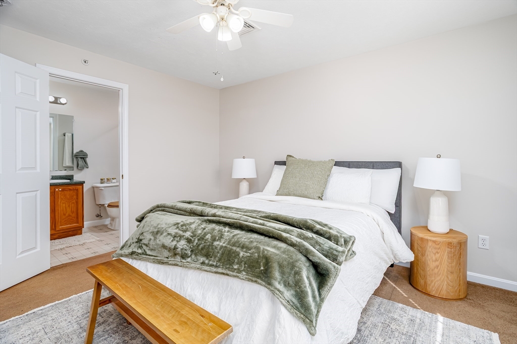 104 Lake Street, Unit 104 Gardner, MA 01440 - Photo 16 of 30 a bedroom with a bed and wooden floor