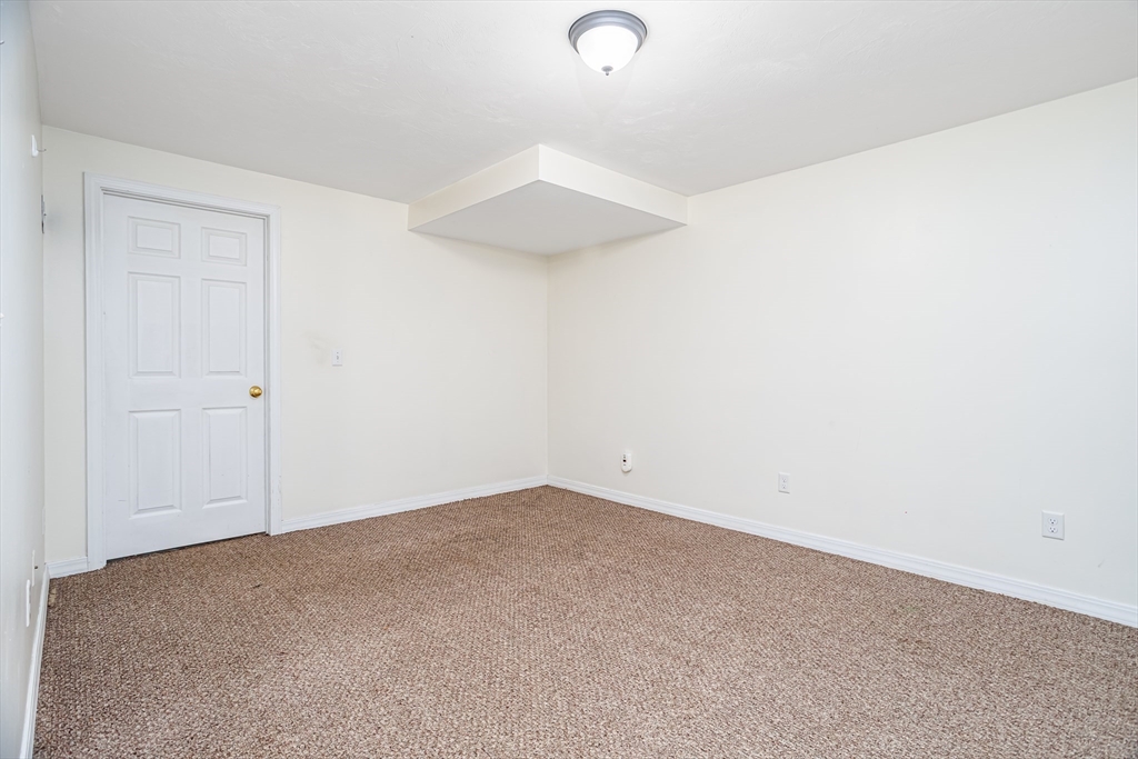 104 Lake Street, Unit 104 Gardner, MA 01440 - Photo 24 of 30 an empty room with a ceiling fan