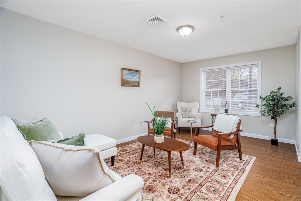 104 Lake Street, Unit 104 Gardner, MA 01440 - Photo 4 of 30 a living room with furniture and a potted plant