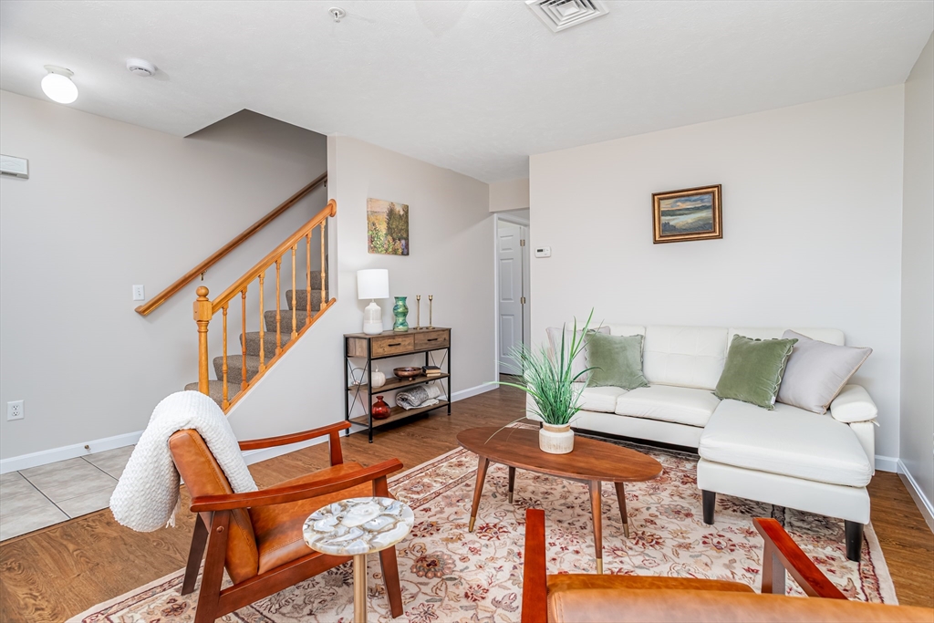 104 Lake Street, Unit 104 Gardner, MA 01440 - Photo 6 of 30 a living room with furniture a rug and a bookshelf