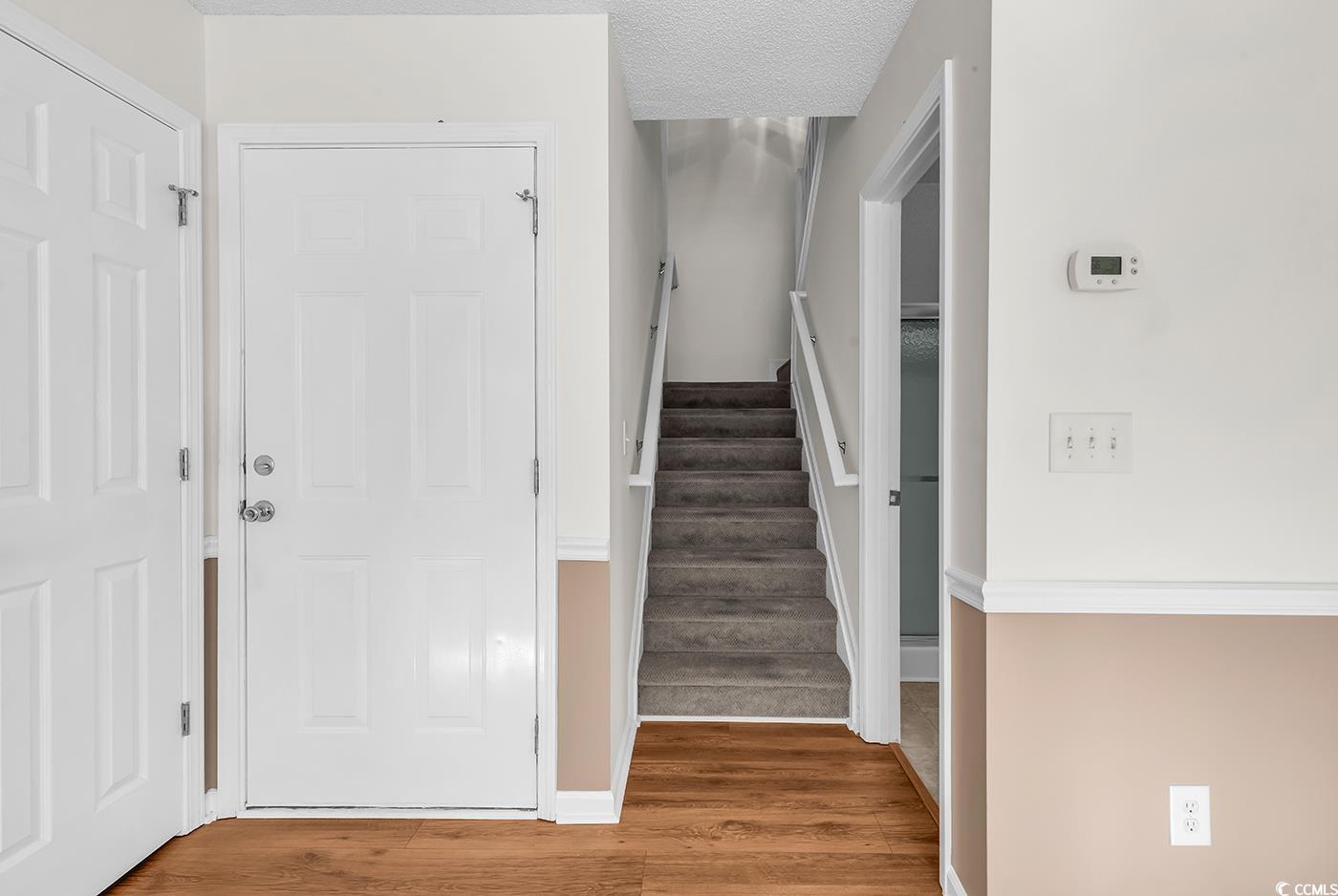 996 Williston Loop, Unit 996 Murrells Inlet, SC 29576 - Photo 26 of 40 Stairway featuring wood finished floors and a textured ceiling