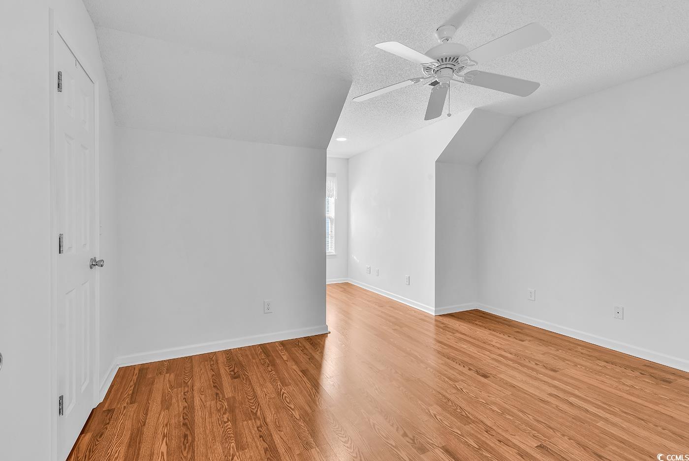 996 Williston Loop, Unit 996 Murrells Inlet, SC 29576 - Photo 27 of 40 Additional living space featuring light wood-style flooring, a textured ceiling, and a ceiling fan