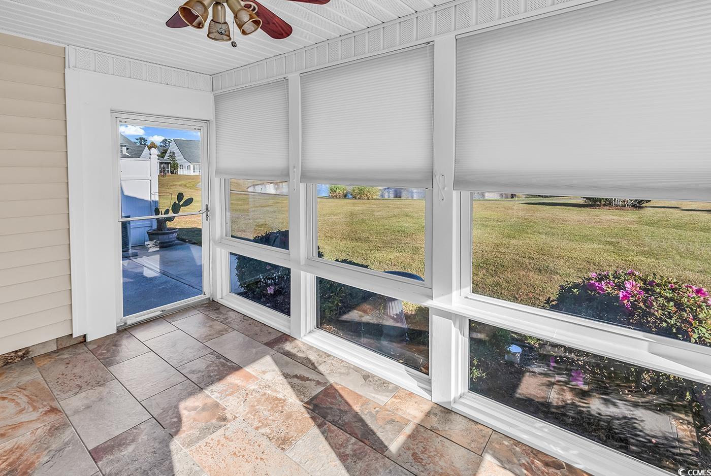 996 Williston Loop, Unit 996 Murrells Inlet, SC 29576 - Photo 8 of 40 Unfurnished sunroom with ceiling fan