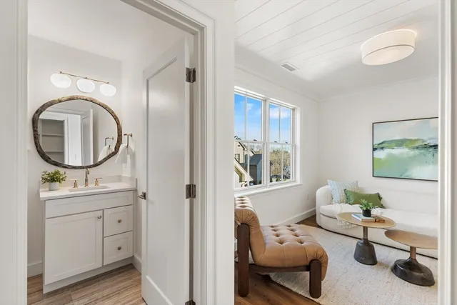 a living room with furniture and a mirror