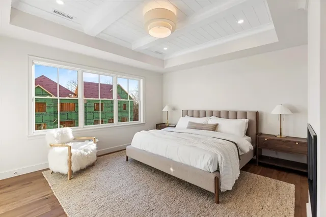 a spacious bedroom with a bed and a large window