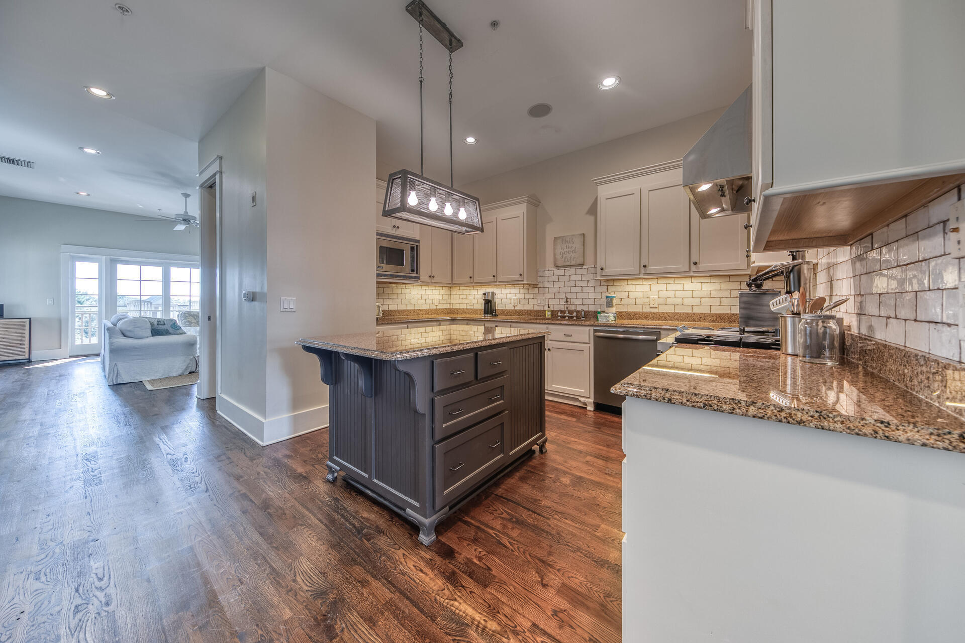 5231 East County Highway 30A, Unit E Santa Rosa Beach, FL 32459 - Photo 15 of 41 a kitchen with stainless steel appliances granite countertop a sink a stove and a wooden floors