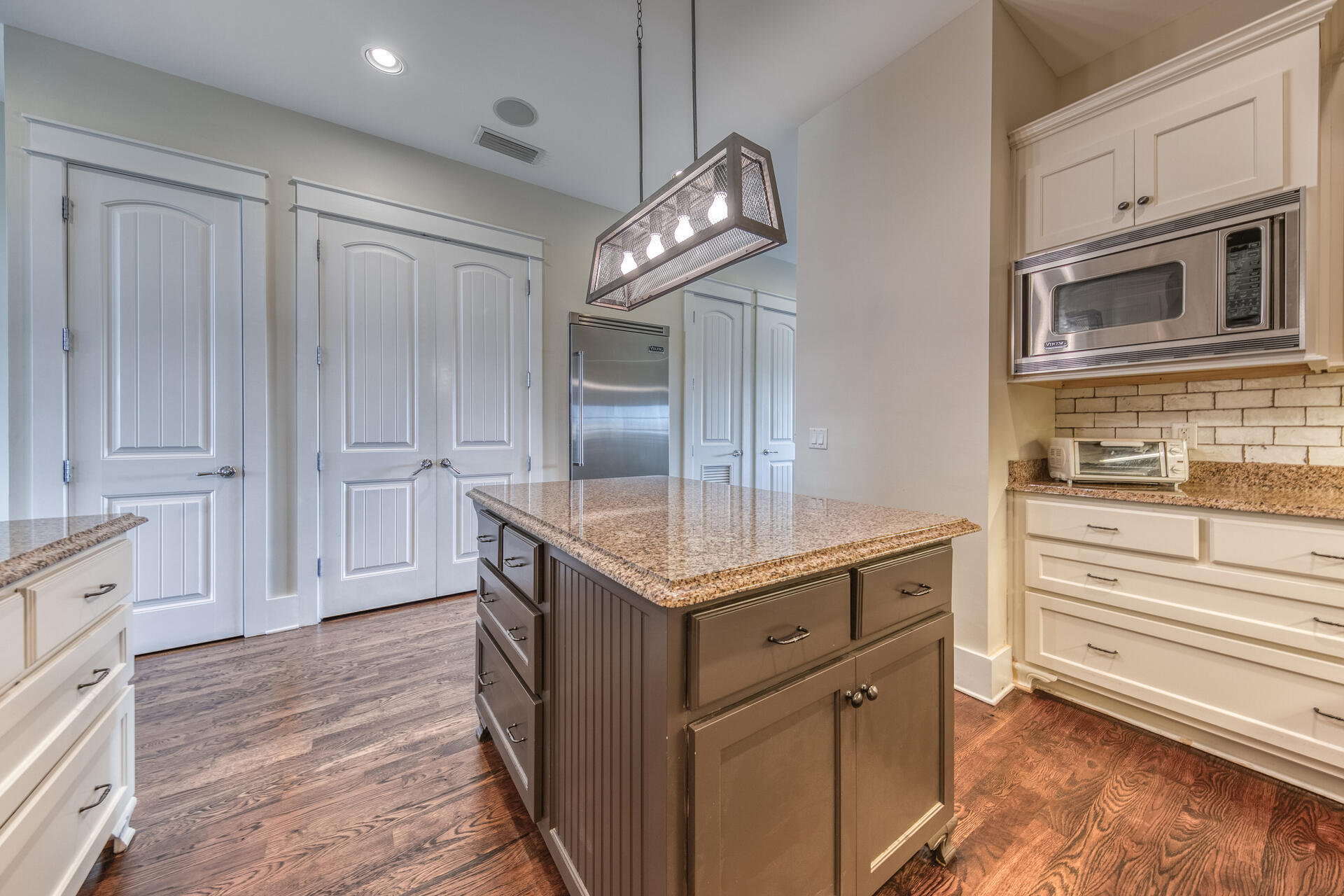 5231 East County Highway 30A, Unit E Santa Rosa Beach, FL 32459 - Photo 21 of 41 a kitchen with granite countertop cabinets and chandelier