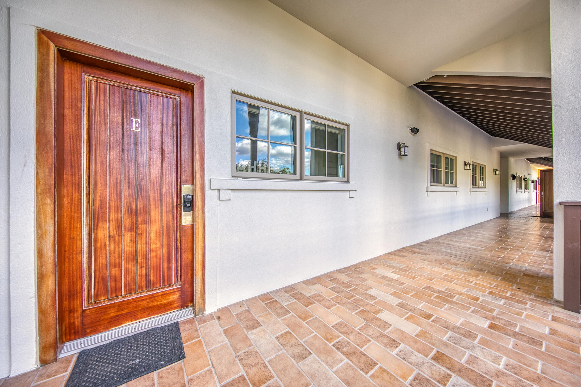 5231 East County Highway 30A, Unit E Santa Rosa Beach, FL 32459 - Photo 4 of 41 a view of a hallway with wooden floor and a bathroom