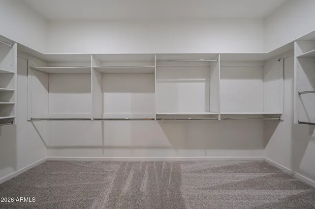 a view of walk in closet with empty racks