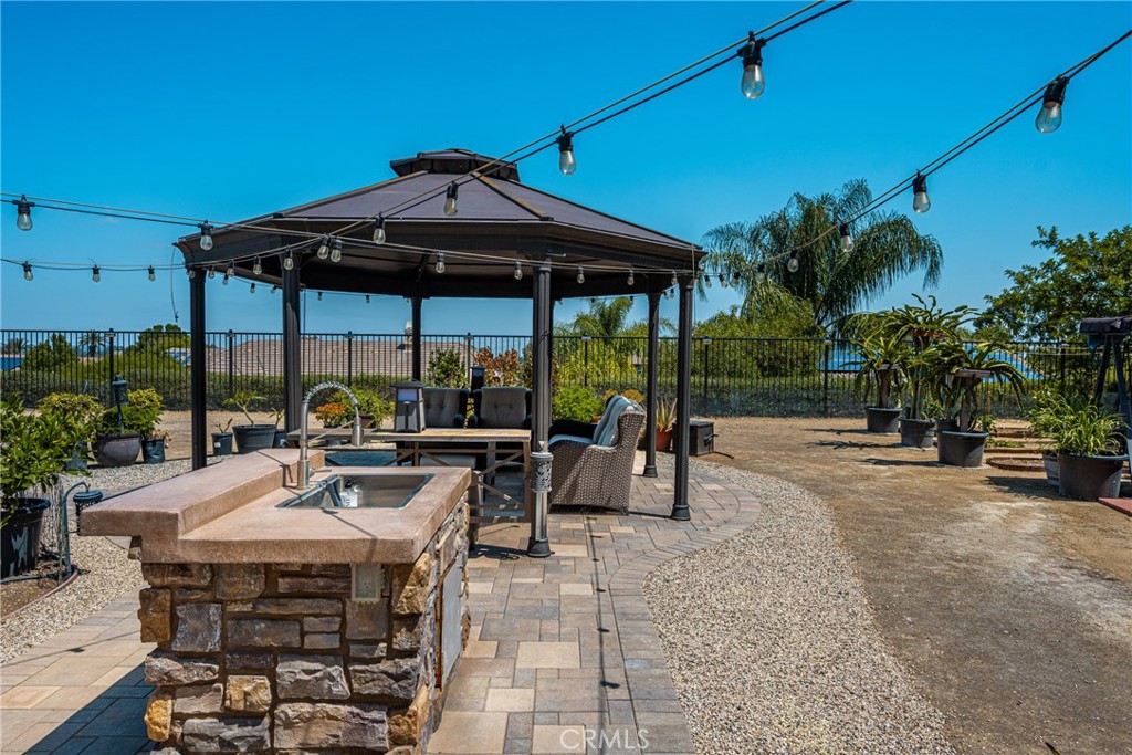 12652 Twin Peak Court Riverside, CA 92503 - Photo 41 of 55 a view of a patio with a table and chairs under an umbrella