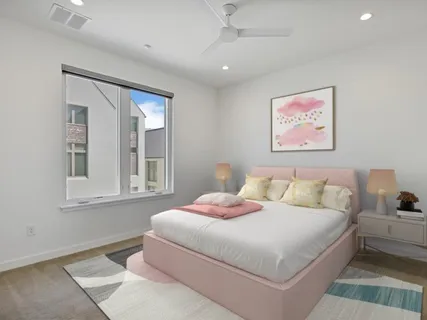 a bedroom with a bed and a painting on the wall