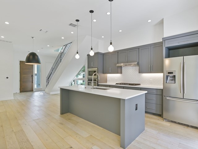 2506 Sutherland Street Austin, TX 78746 - Photo 12 of 17 a kitchen with stainless steel appliances granite countertop a sink a stove and a refrigerator