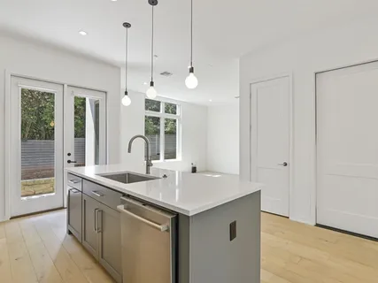 a kitchen with a sink and chandelier