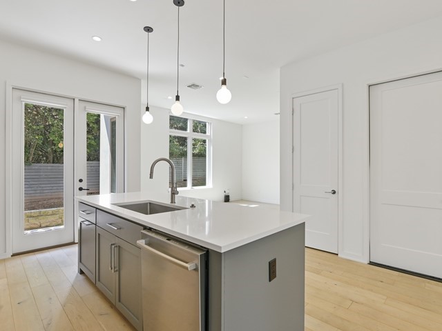 2506 Sutherland Street Austin, TX 78746 - Photo 4 of 17 a kitchen with a sink and chandelier