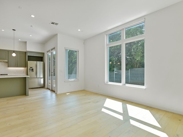 2506 Sutherland Street Austin, TX 78746 - Photo 6 of 17 a view of an empty room with a window and a kitchen