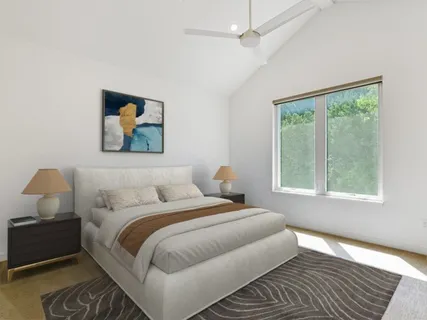 a bedroom with bed and window