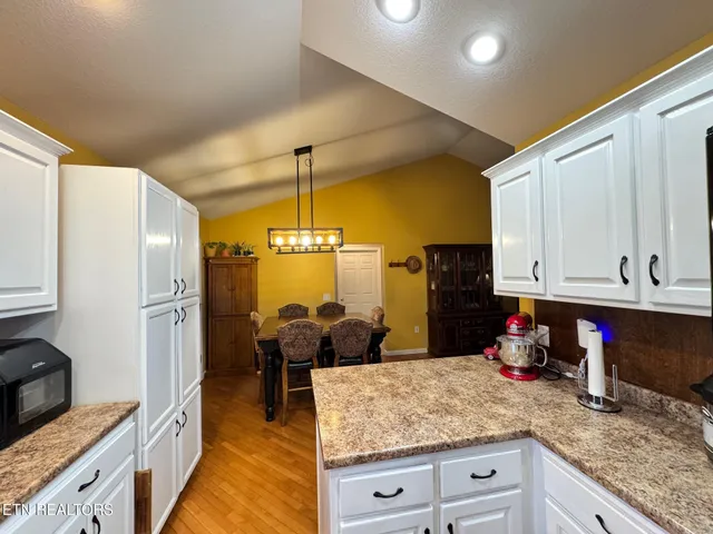 a dining room with furniture and chandelier