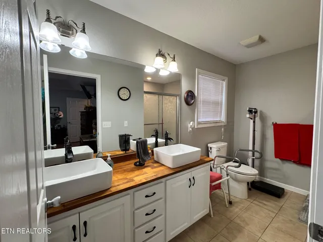a spacious bathroom with a double vanity sink and a mirror