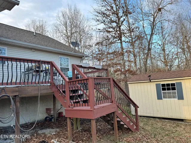 a view of a roof deck with wooden fence and floor