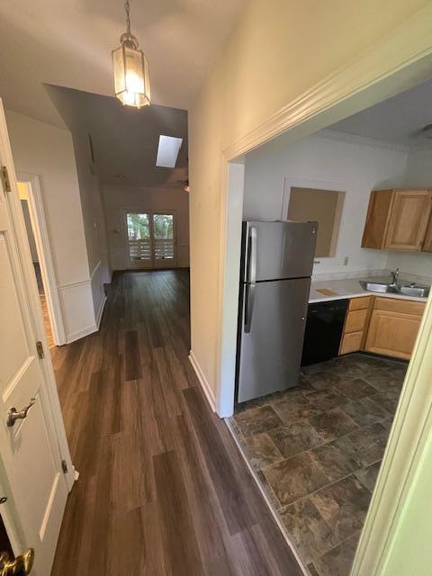 103 Danforth Drive Cary, NC 27511 - Photo 2 of 13 a view of a refrigerator in kitchen and an empty room with wooden floor kitchen view