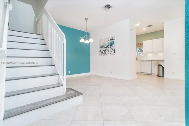 a view of a hallway with wooden floor and entryway
