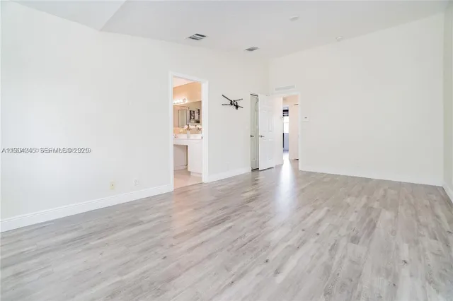 a bathroom with a double vanity sink mirror and bathtub
