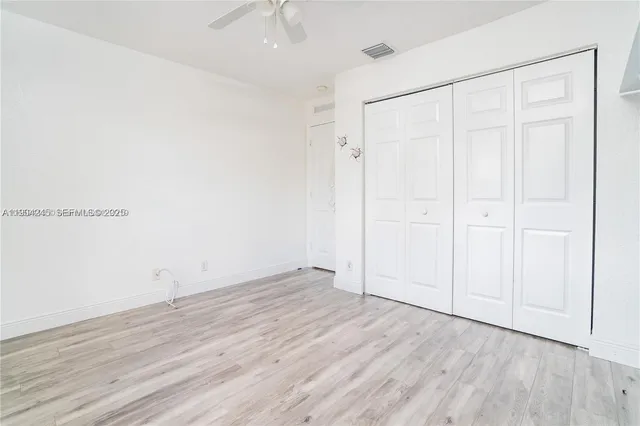 a bathroom with a granite countertop sink and a toilet