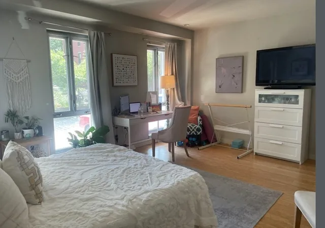 a bed room with a bed and a television