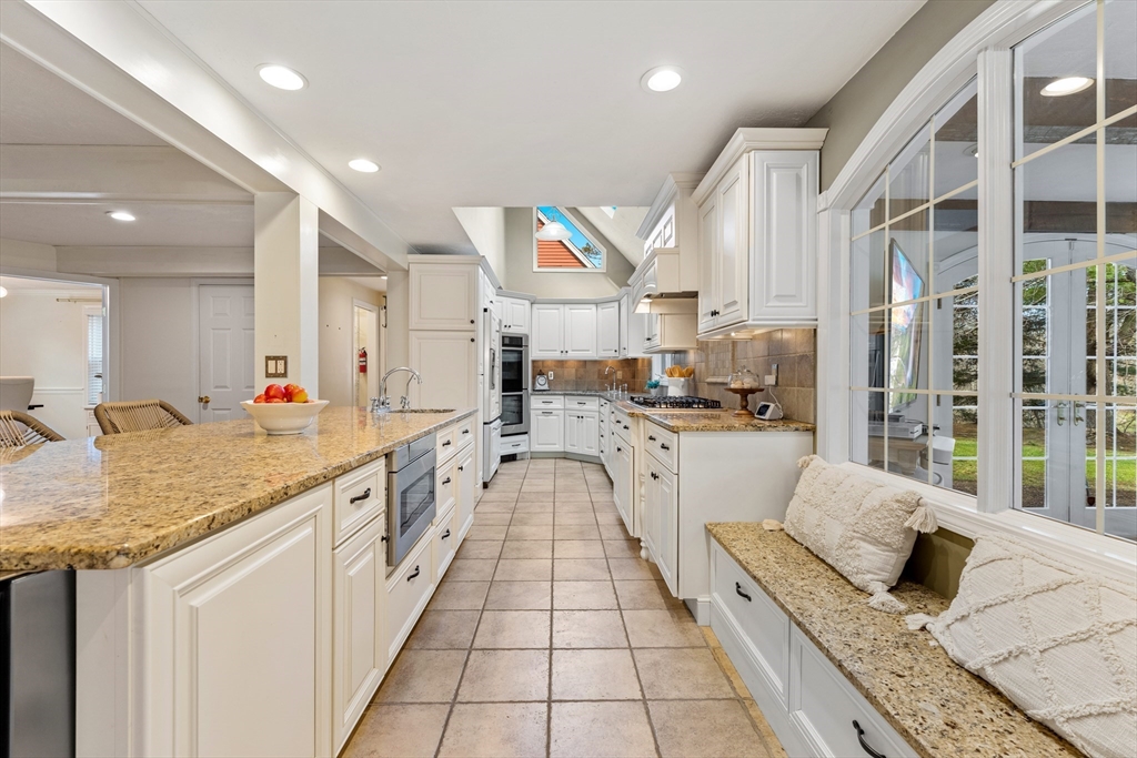 63 Farm Hill Road North Attleboro, MA 02760 - Photo 7 of 42 a large white kitchen with granite countertop lots of counter space