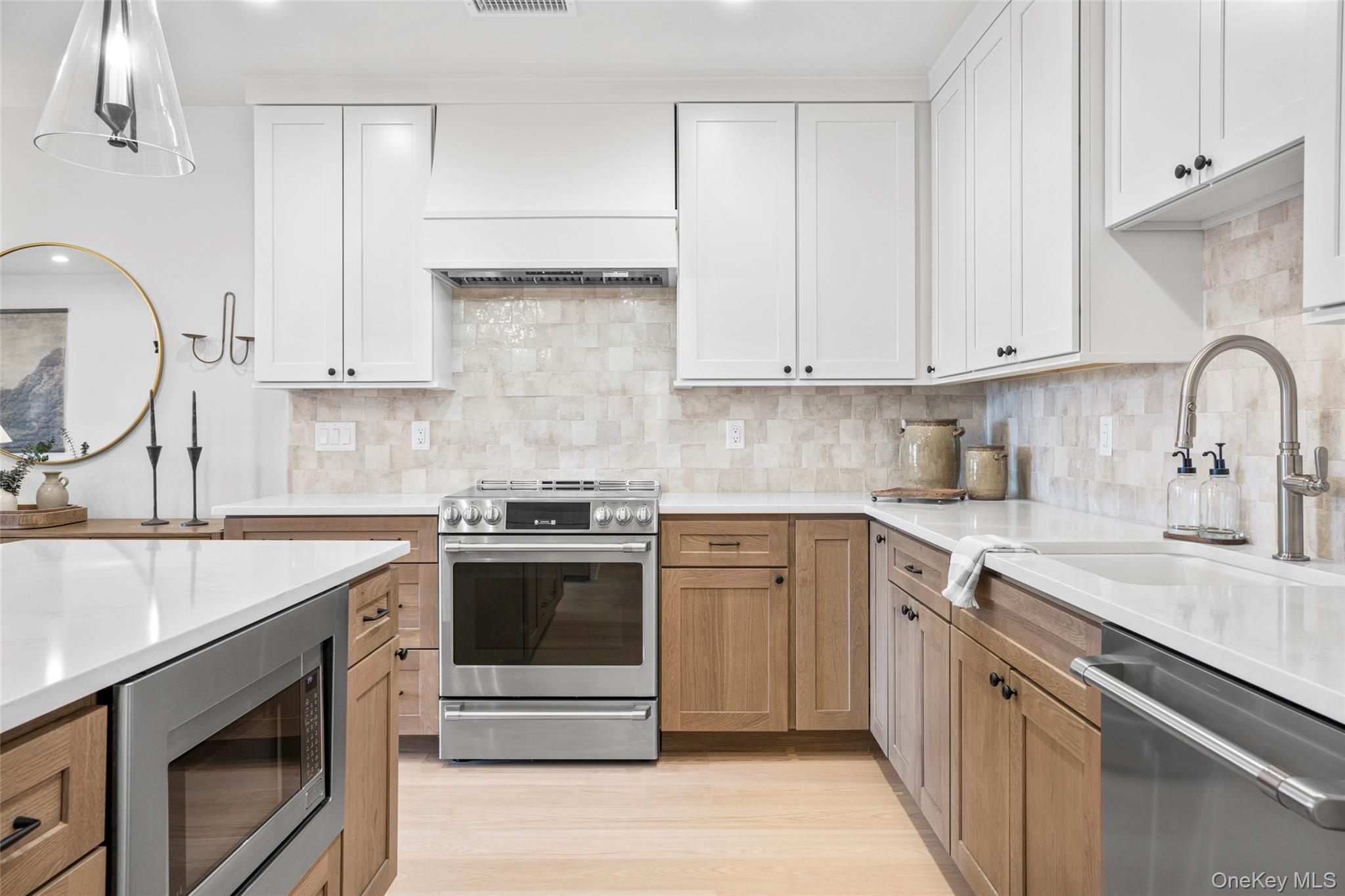 25 North Riverside Avenue, Unit 211 Croton-on-Hudson, NY 10520 - Photo 4 of 27 a kitchen with granite countertop white cabinets and white appliances