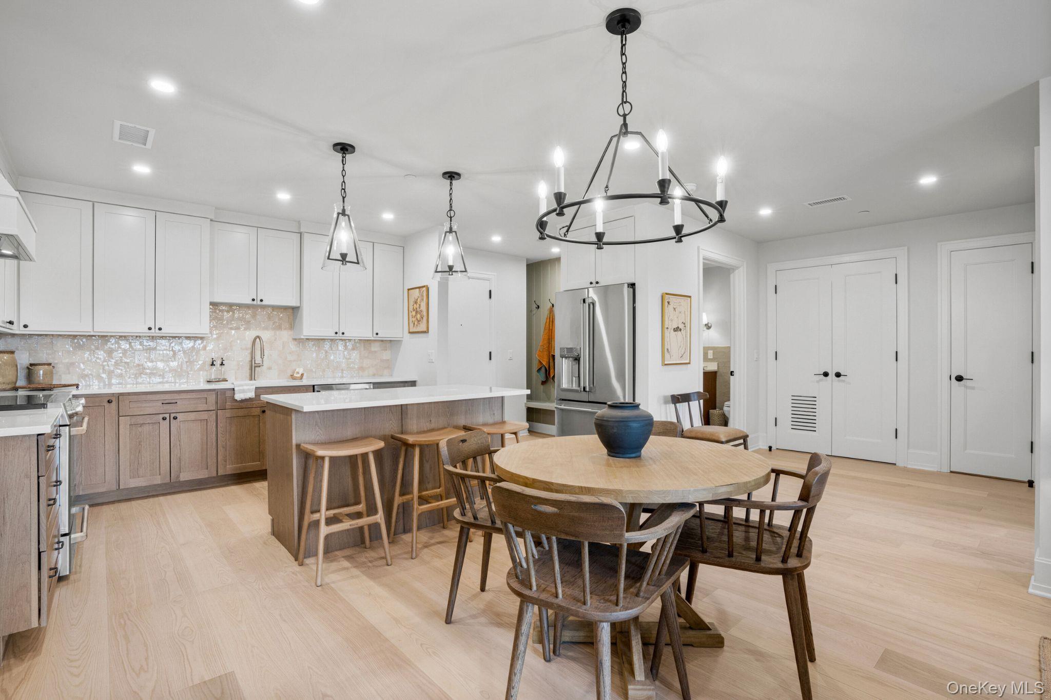 25 North Riverside Avenue, Unit 211 Croton-on-Hudson, NY 10520 - Photo 5 of 27 a large kitchen with a table and chairs in it
