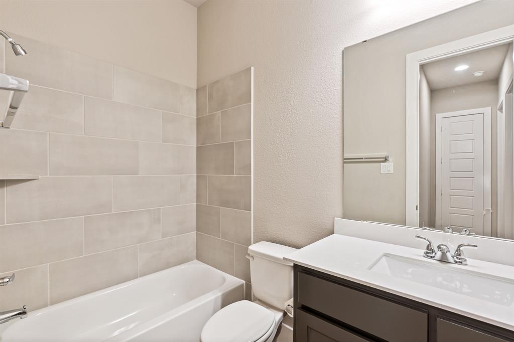 1314 Buttermere Street Forney, TX 75126 - Photo 18 of 32 a bathroom with a sink toilet vanity and shower