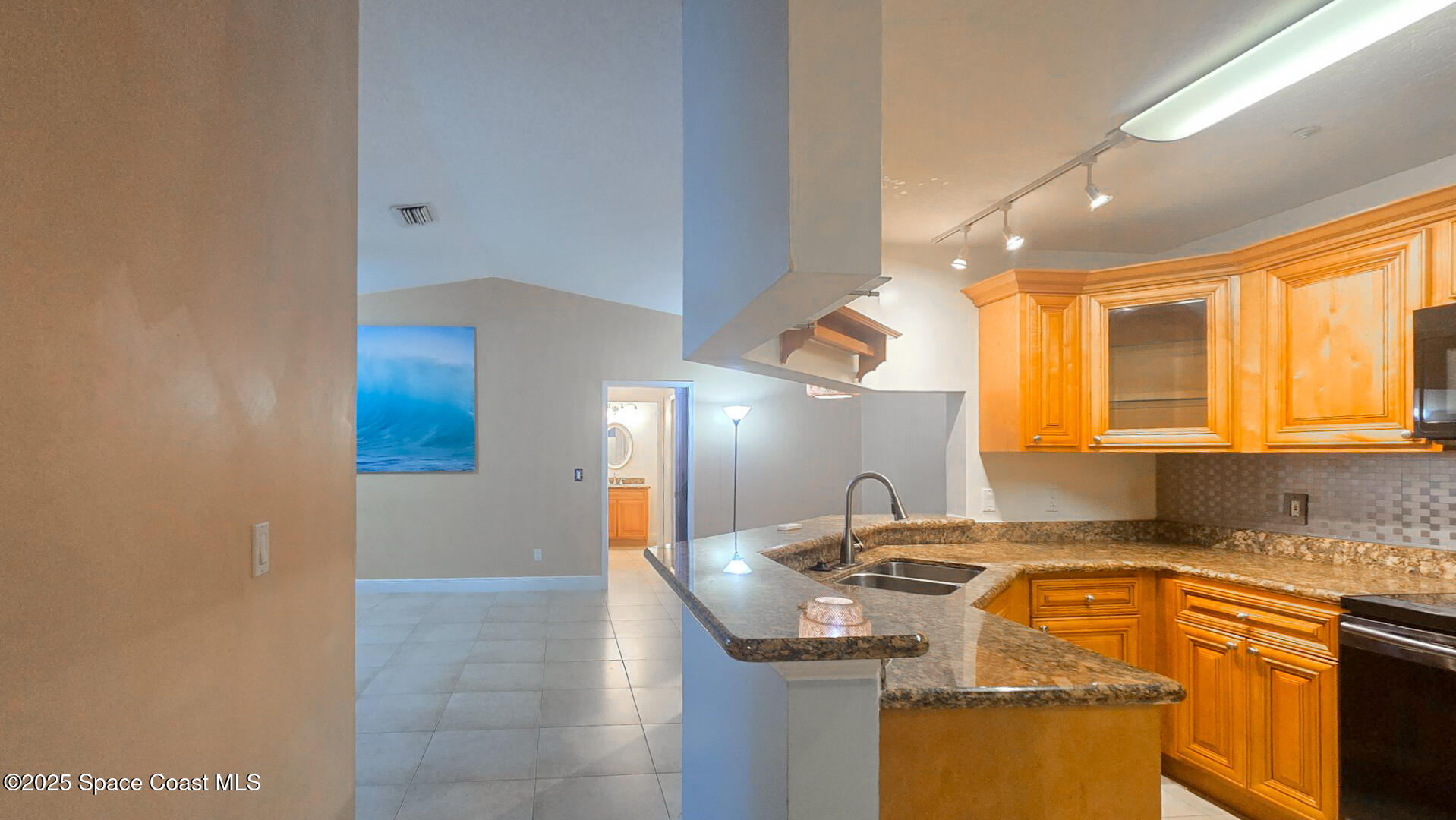 7667 North Wickham Road, Unit 522 Melbourne, FL 32940 - Photo 11 of 29 a kitchen with a sink cabinets and a wooden floor