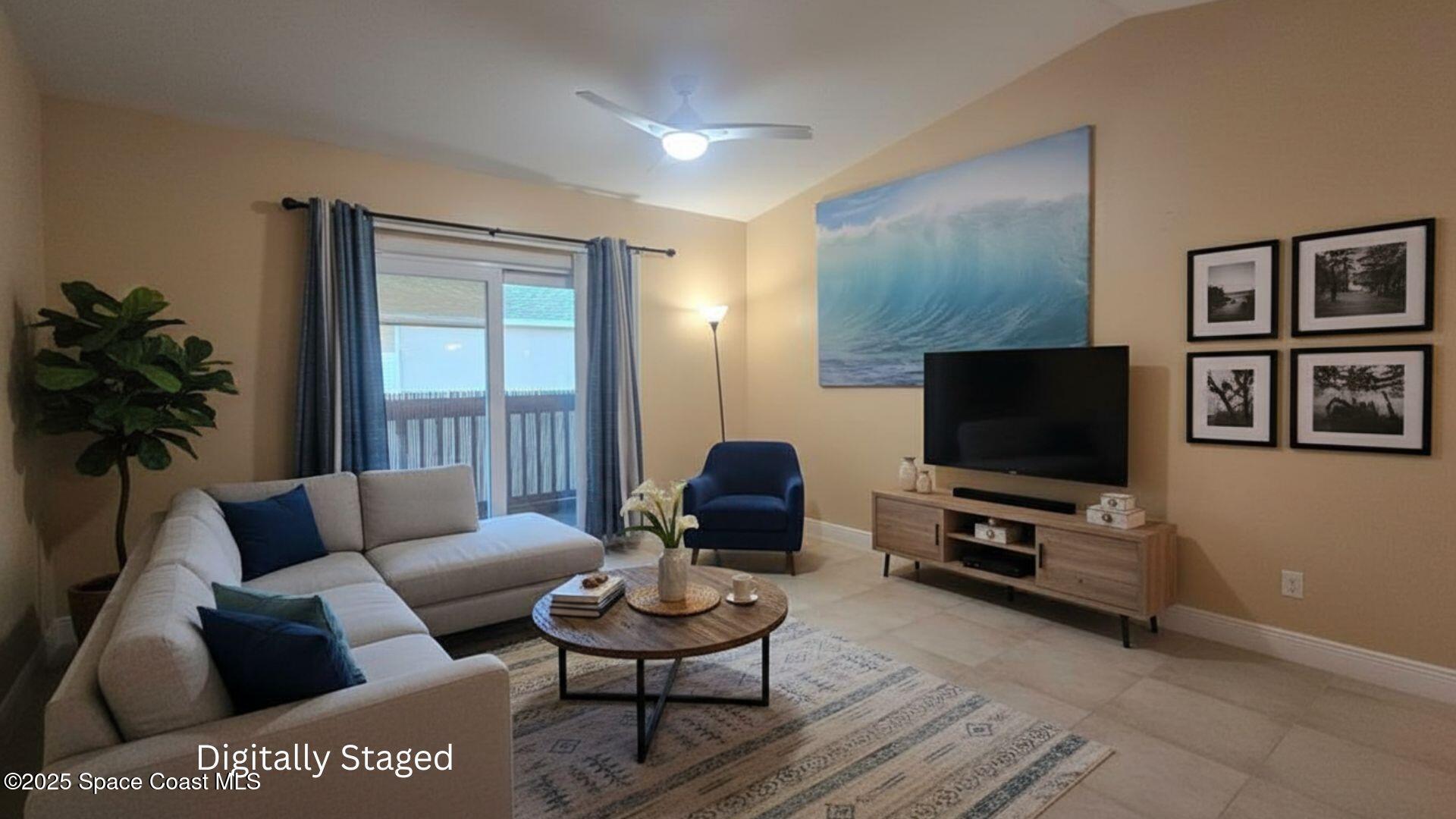 7667 North Wickham Road, Unit 522 Melbourne, FL 32940 - Photo 5 of 29 a living room with furniture and a flat screen tv