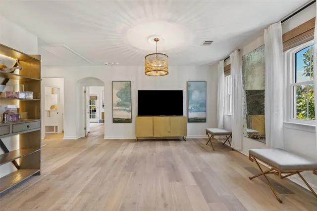 a outdoor living room with furniture and wooden floor