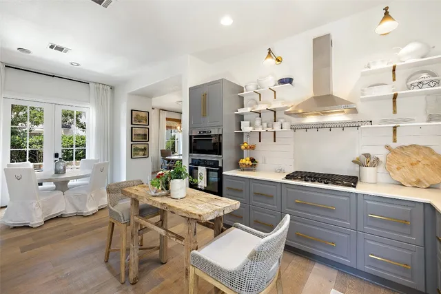 a living room with furniture a chandelier and a window
