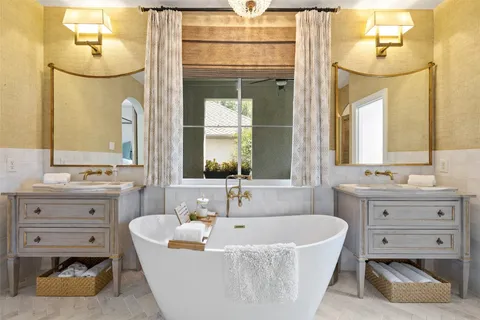 a dining room with furniture a chandelier and wooden floor
