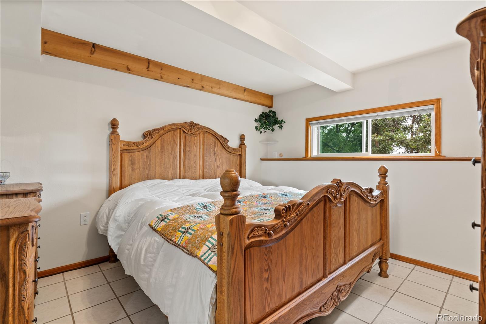 64 Highland Road Palmer Lake, CO 80133 - Photo 11 of 17 a bed sitting in a bedroom next to a window