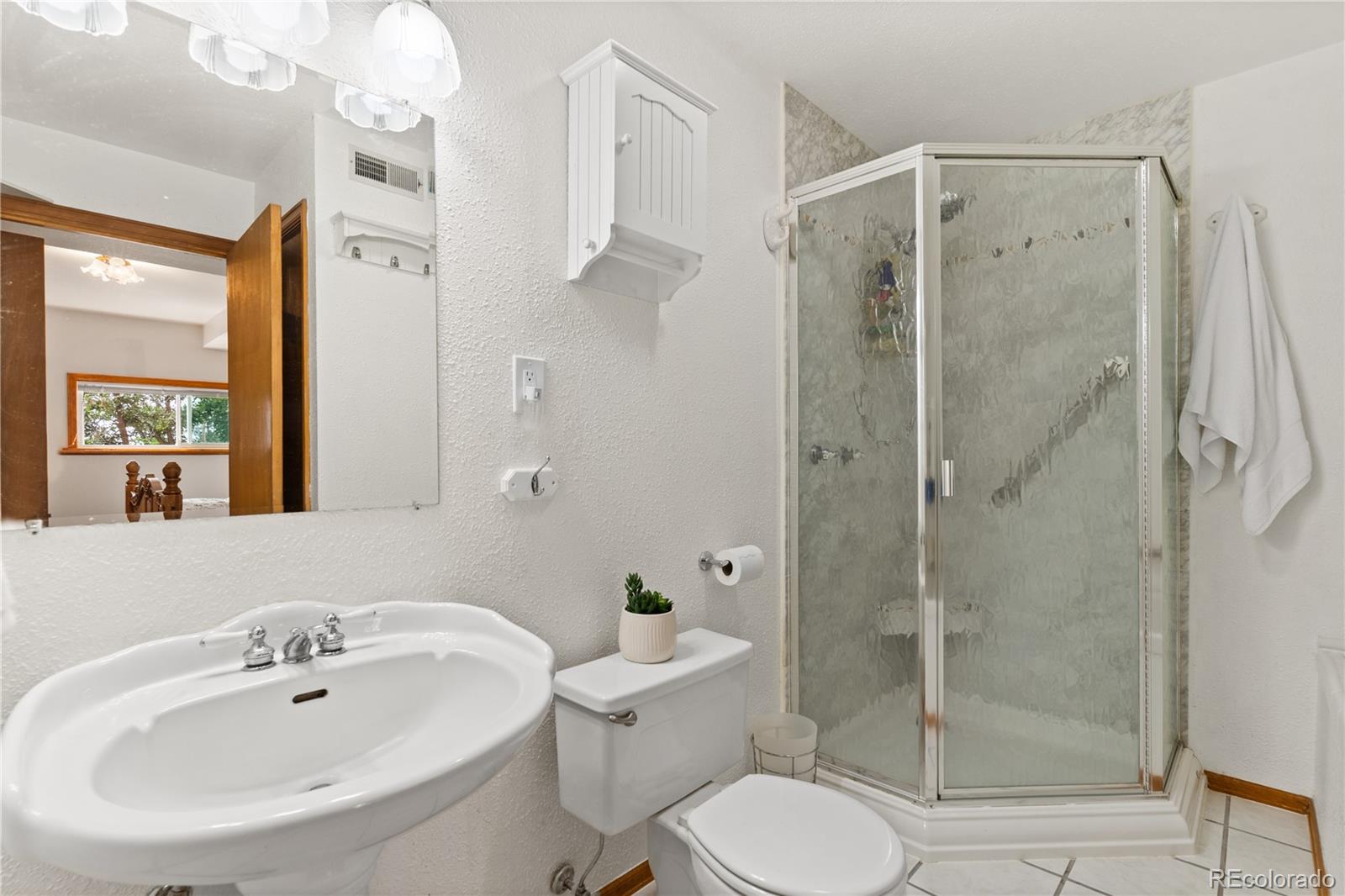 64 Highland Road Palmer Lake, CO 80133 - Photo 12 of 17 a bathroom with a shower a toilet and a sink