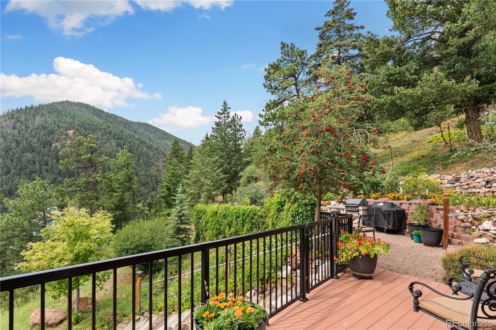 64 Highland Road Palmer Lake, CO 80133 - Photo 15 of 17 a view of a balcony with couches and wooden floor