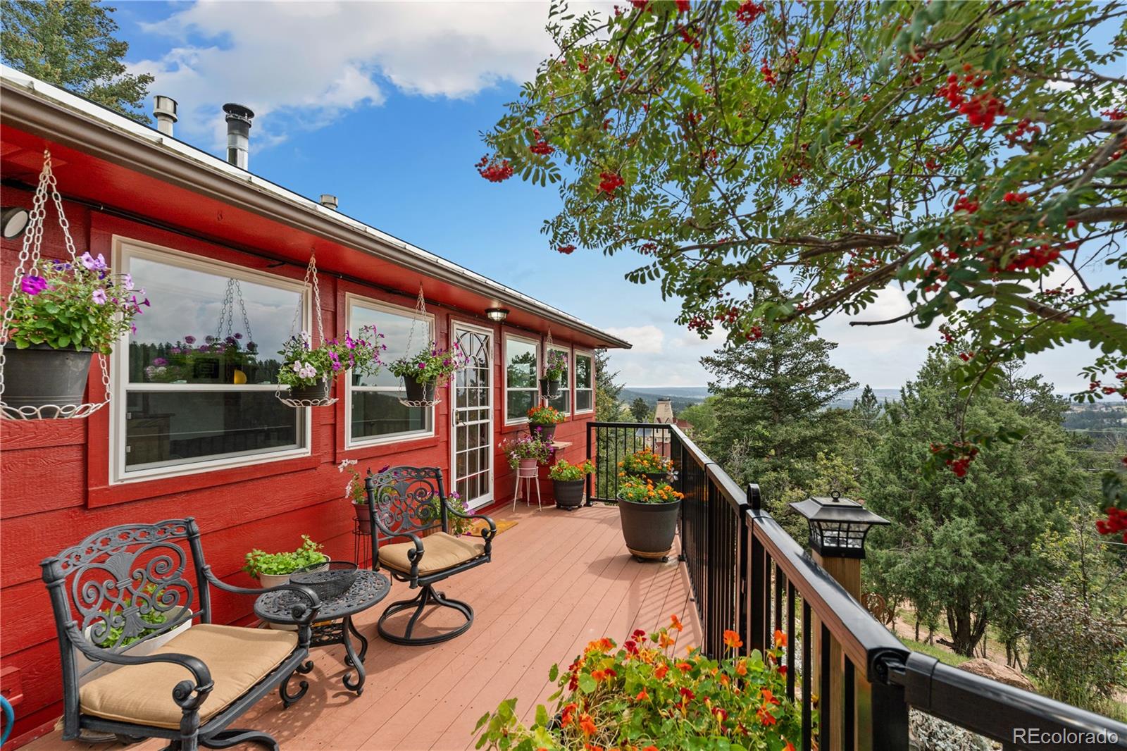 64 Highland Road Palmer Lake, CO 80133 - Photo 16 of 17 a view of a chairs and tables in the balcony