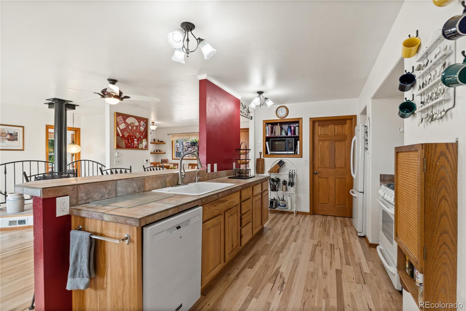 64 Highland Road Palmer Lake, CO 80133 - Photo 8 of 17 a kitchen with stainless steel appliances granite countertop a sink and a refrigerator