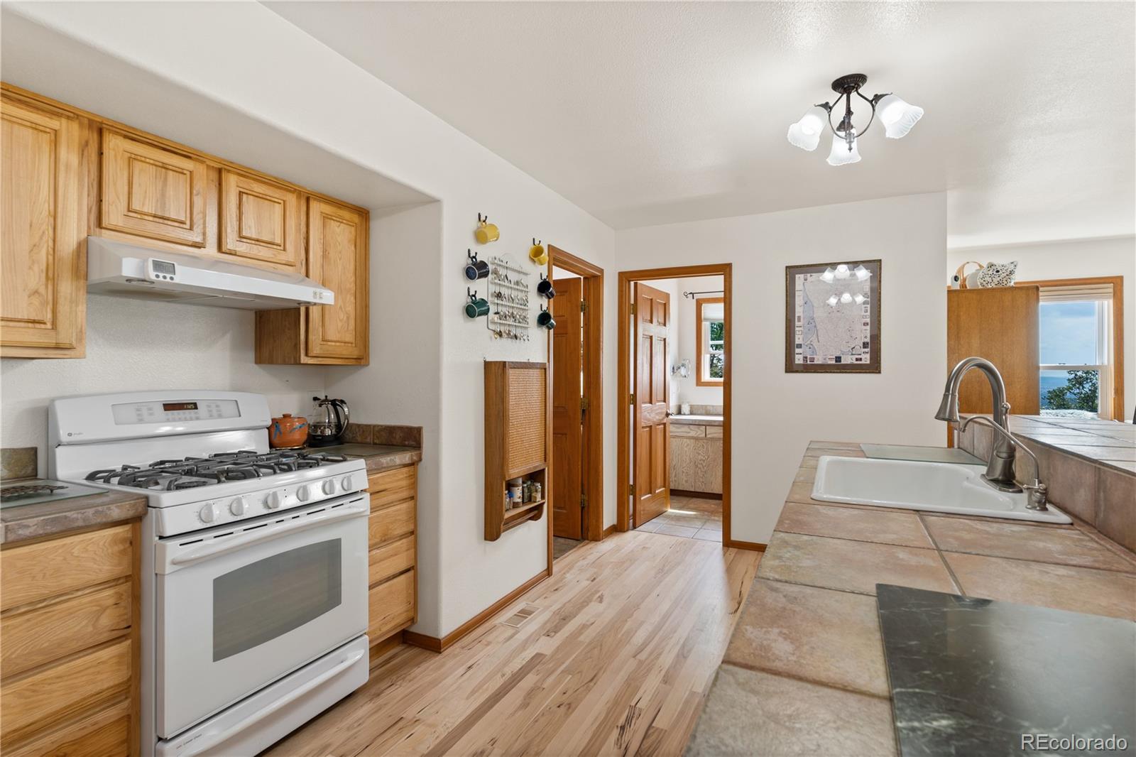64 Highland Road Palmer Lake, CO 80133 - Photo 9 of 17 a kitchen with stainless steel appliances granite countertop a stove and a refrigerator